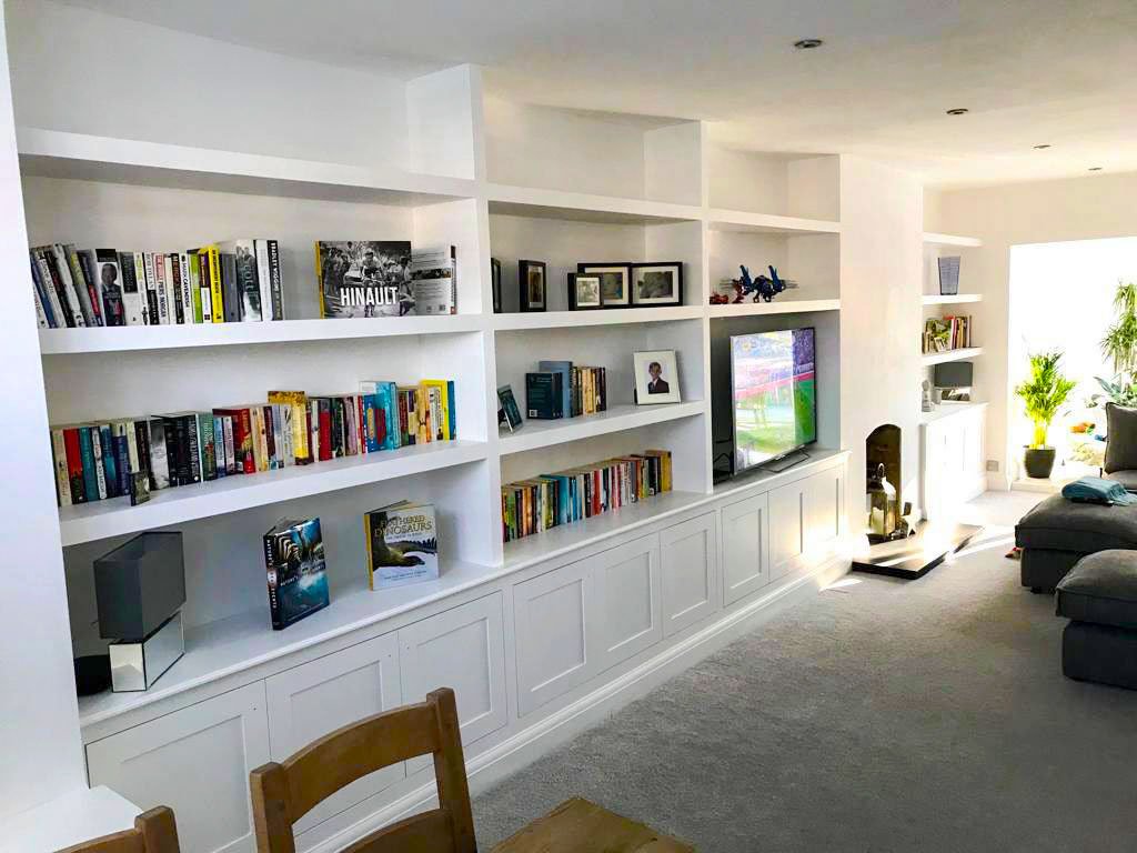 Feature wall shelving in a living room with TV.